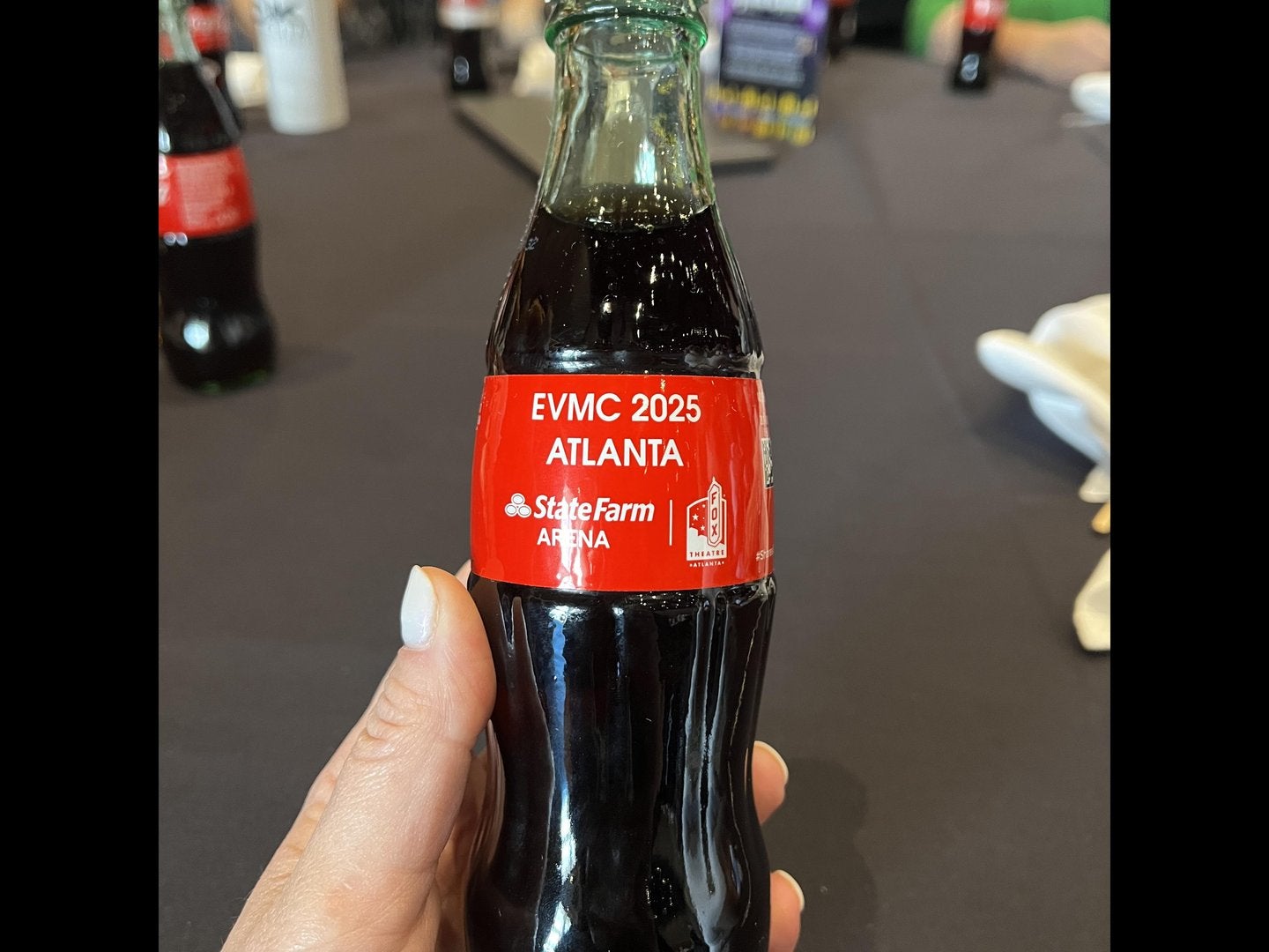 Custom EVMC 2025 Coke bottle announcing the site of EVMC 2025 in Atlanta.