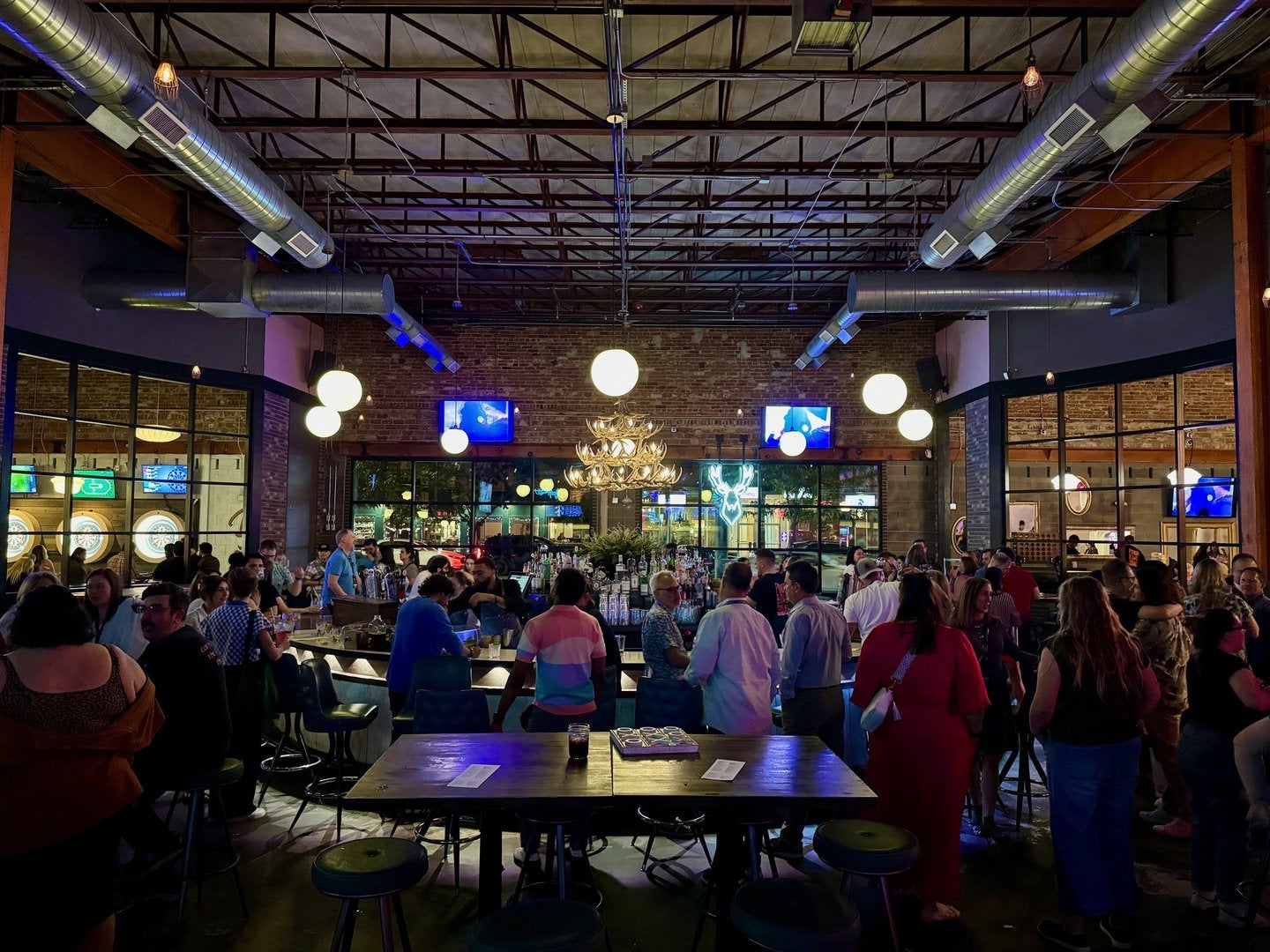 EVMC attendees surround the bar at Punch Bowl Social in Denver.